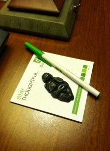 Image description: a Venus of Willendorf totem on a Holiday Inn notepad.